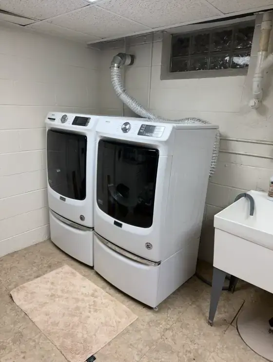 Maytag washer and dryer pair in a basement